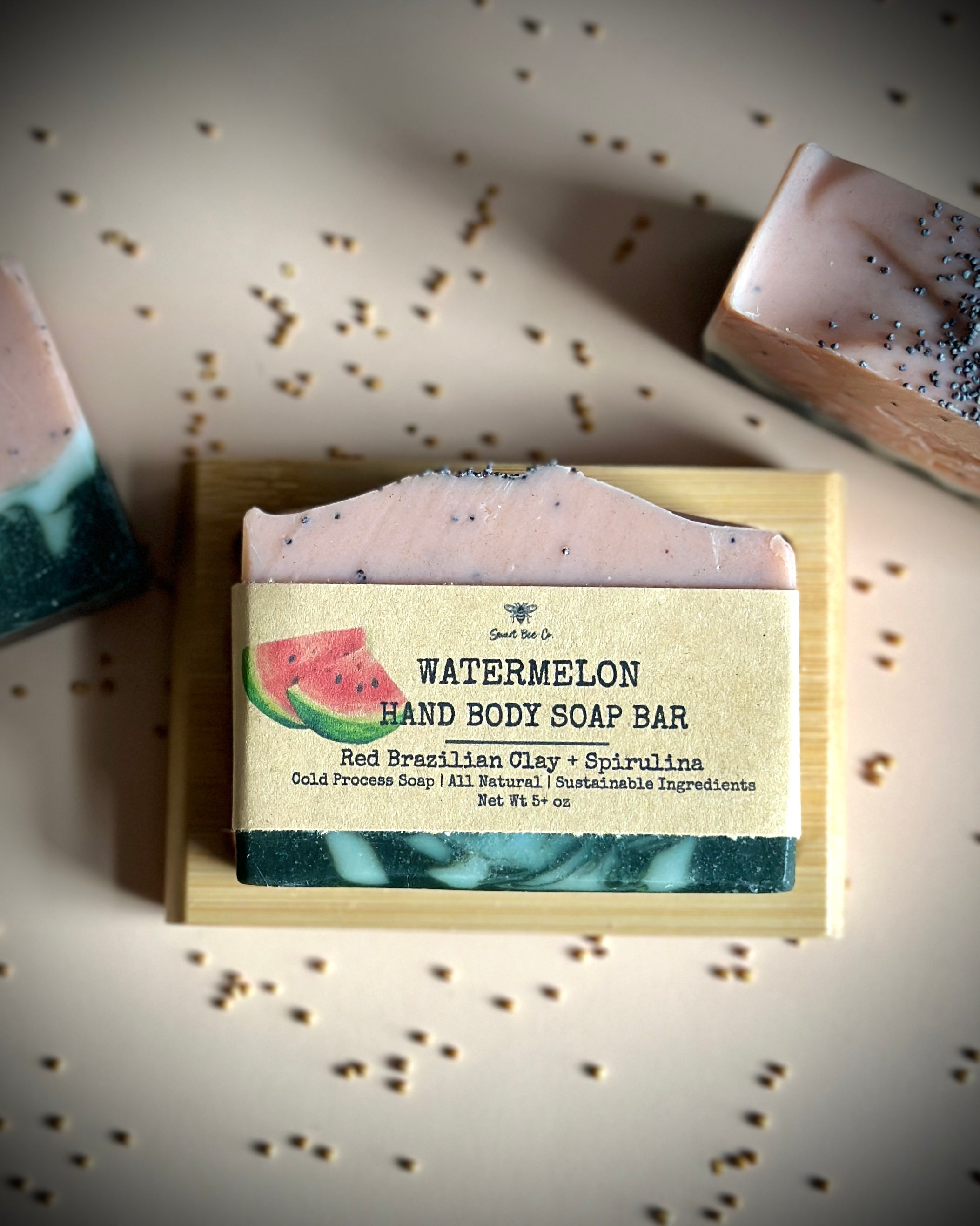 Watermelon hand body soap bar with a label on a textured surface