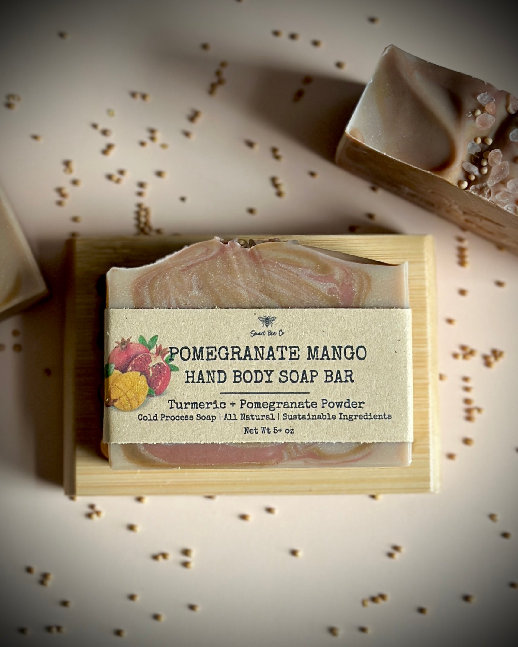 Pomegranate Mango hand body soap bar with packaging on a textured surface